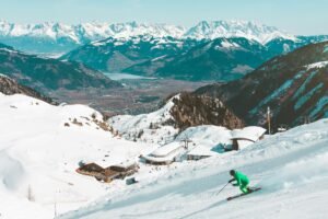 Skiing holiday A skier enjoying the snowy slopes with stunning views of the Kaprun Alps in Austria.